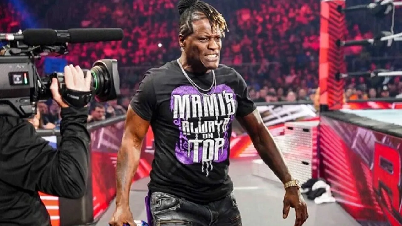 R-Truth holding an empty Lil Jimmy action figure box with a grin